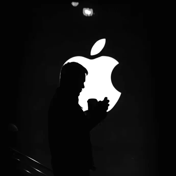 Logo Design A person standing in front of Apple logo